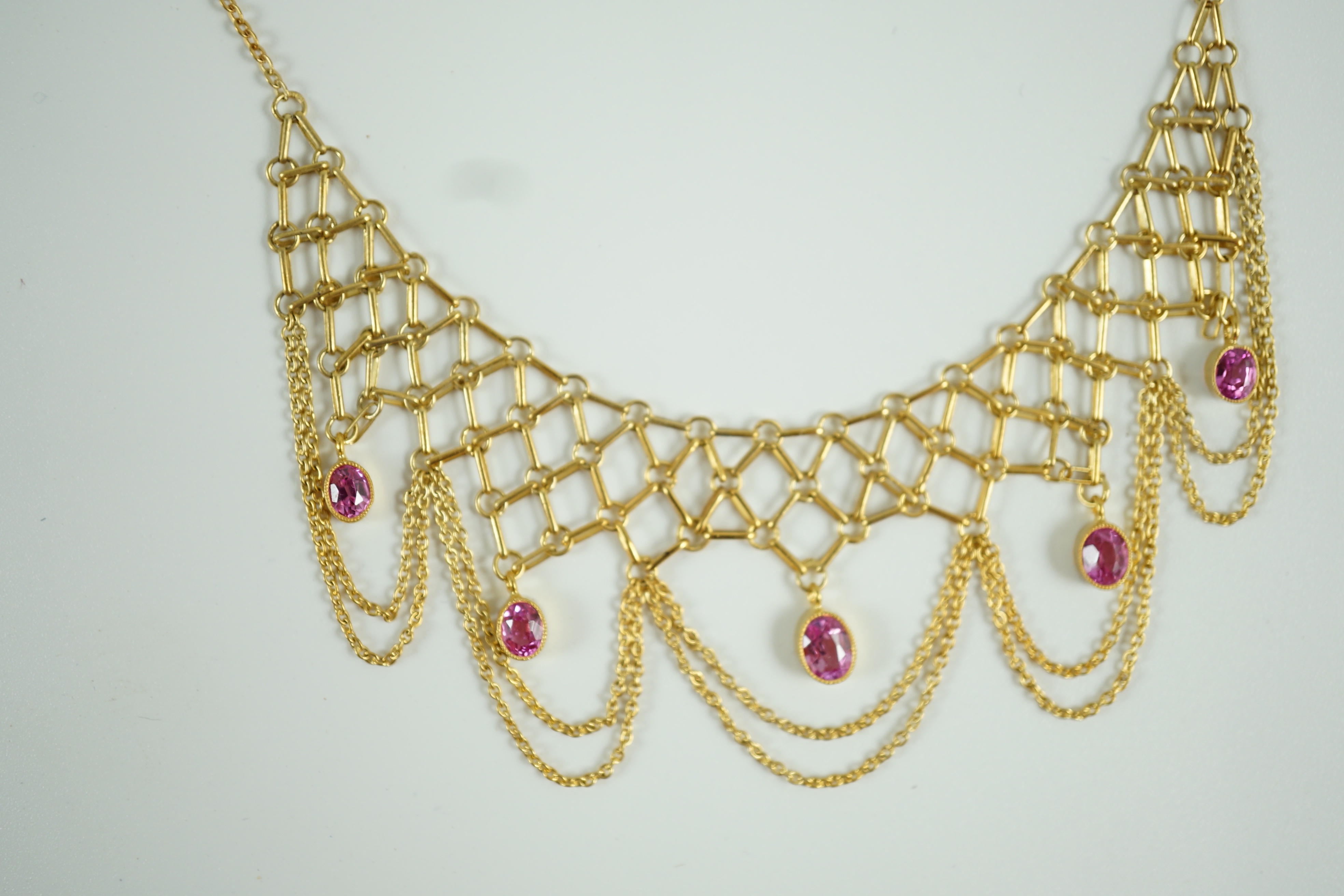 A 20th century 14k gold and five stone oval cut pink topaz set drop fringe necklace